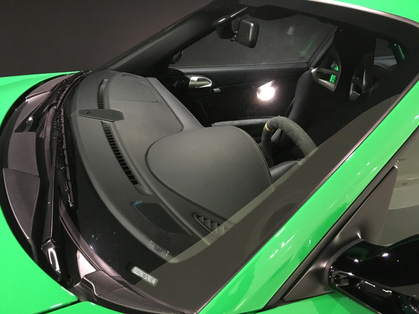 Sporty racing bucket seats with harness slots and Alcantara steering wheel