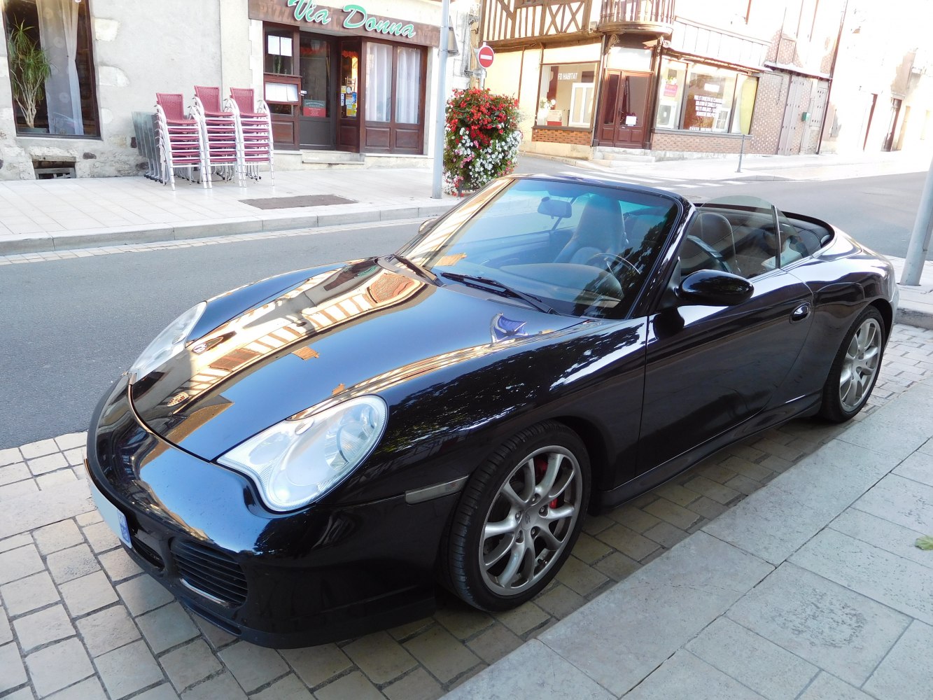 Black convertible sports car with smooth aerodynamic shape and alloy wheels.