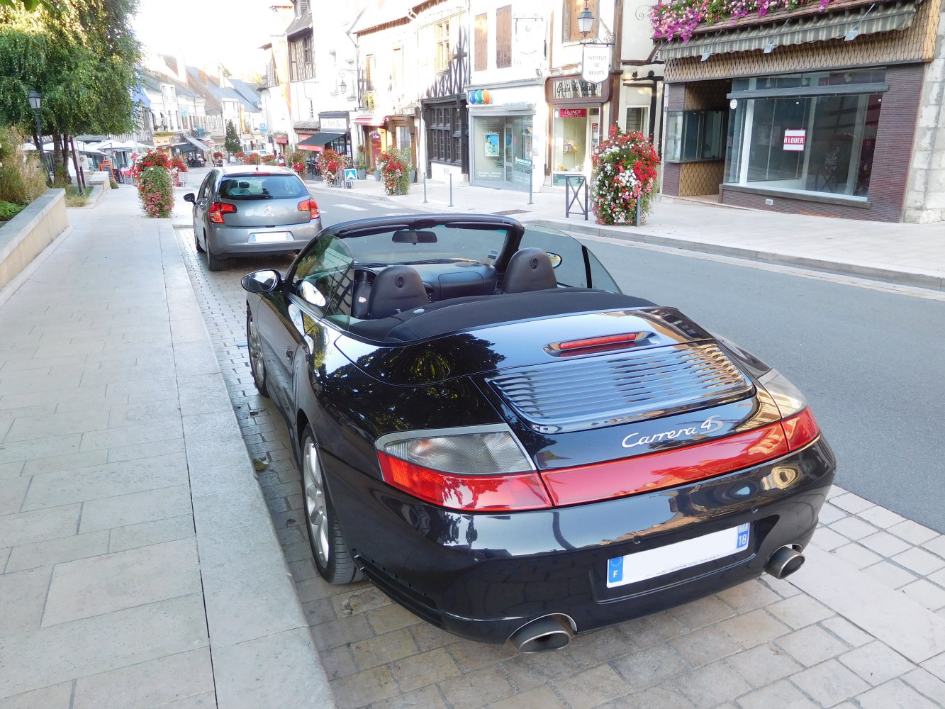Rear view of convertible sports car with dual exhaust and distinctive tail lights