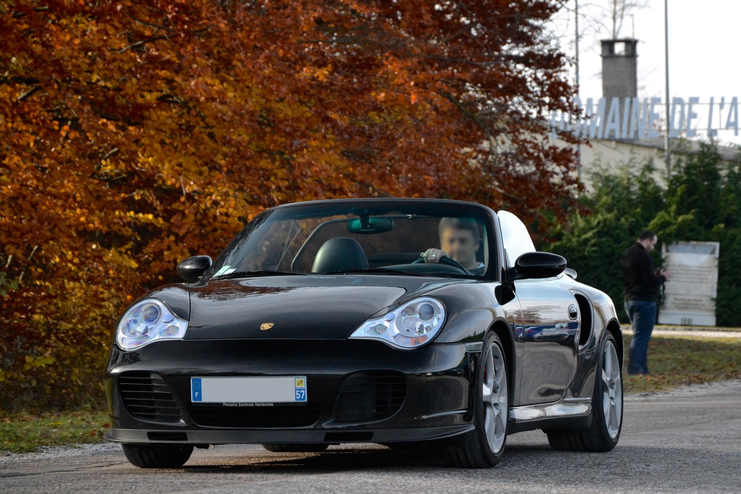 Front view of black convertible with dual rounded headlights and aerodynamic design.