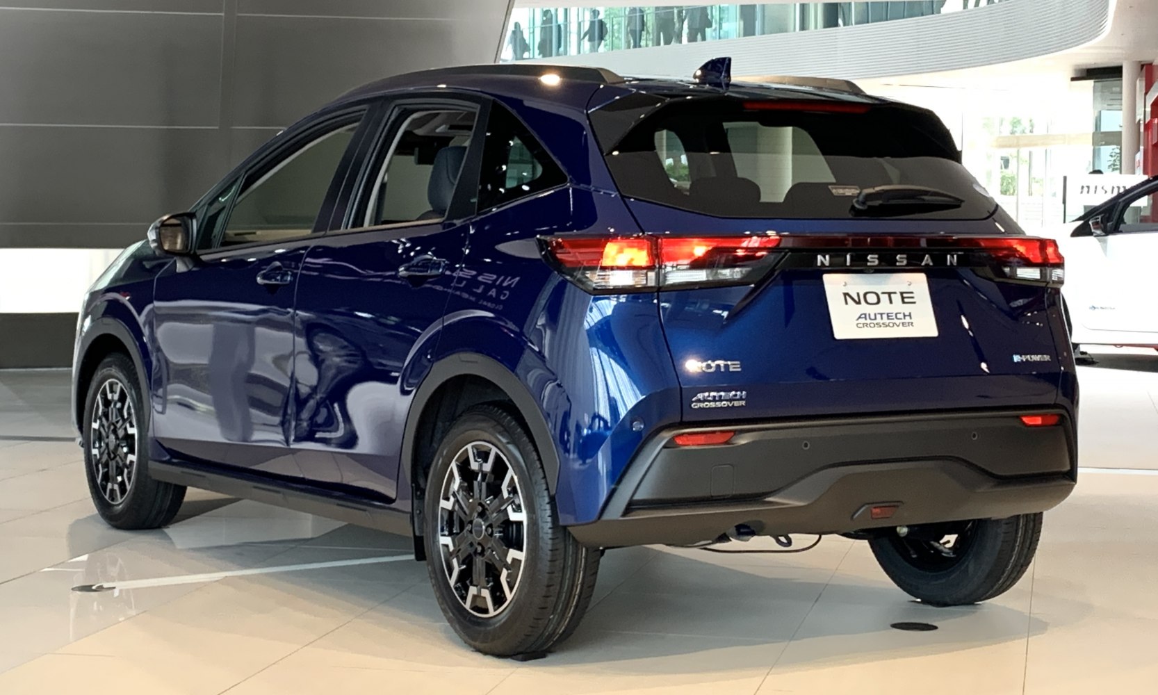 Rear view with illuminated tail lights and modern rims of a crossover hatchback