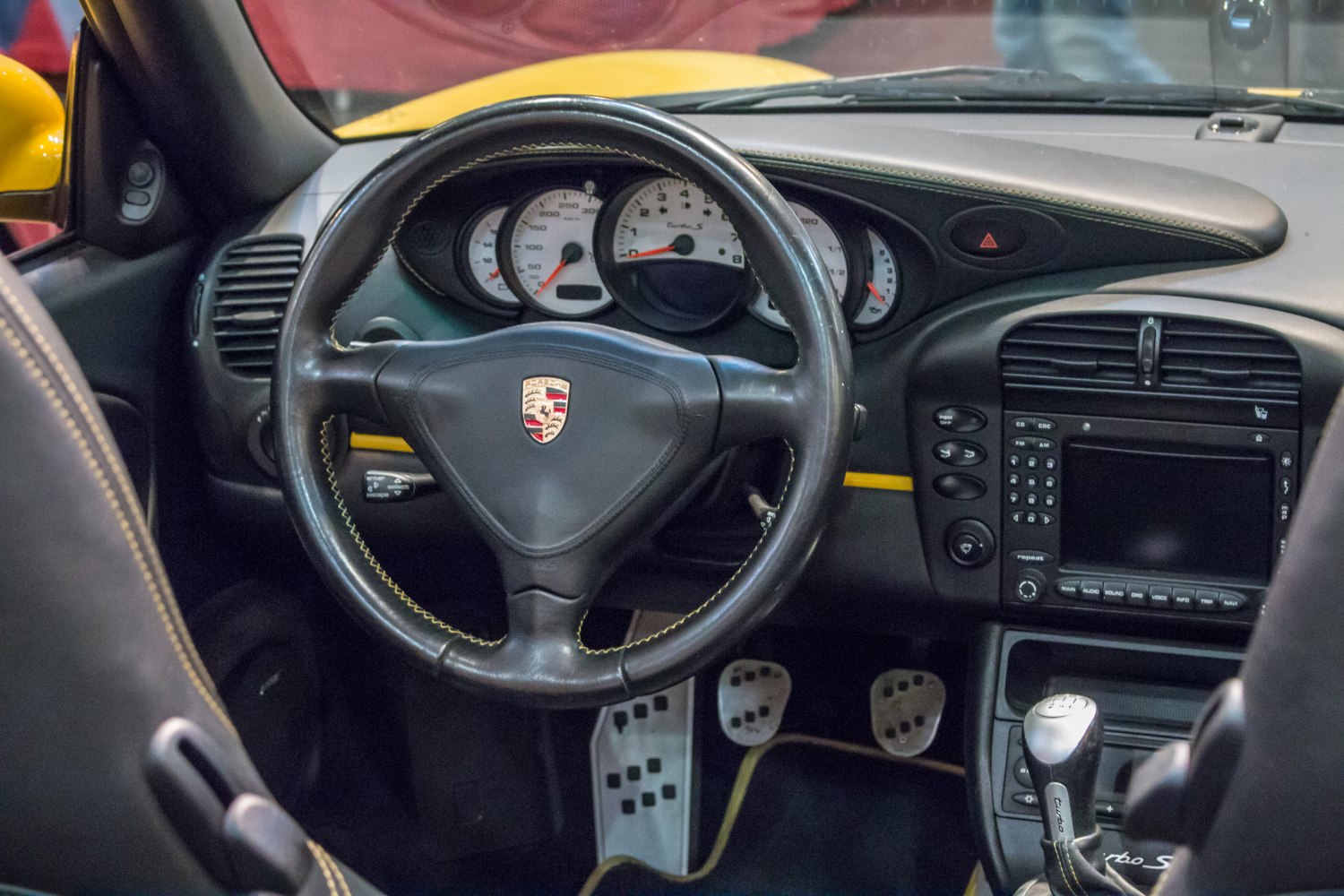 Steering wheel, gauge cluster, manual gearshift inside sports car interior