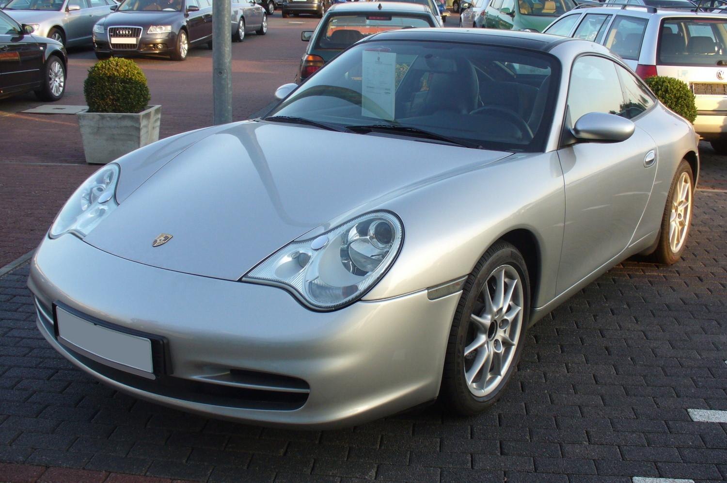 Silver sports coupe with oval headlights and alloy wheels