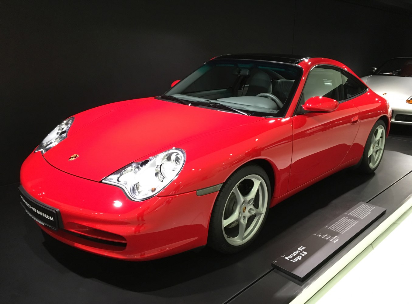 Red sports coupe with distinct headlights and alloy wheels