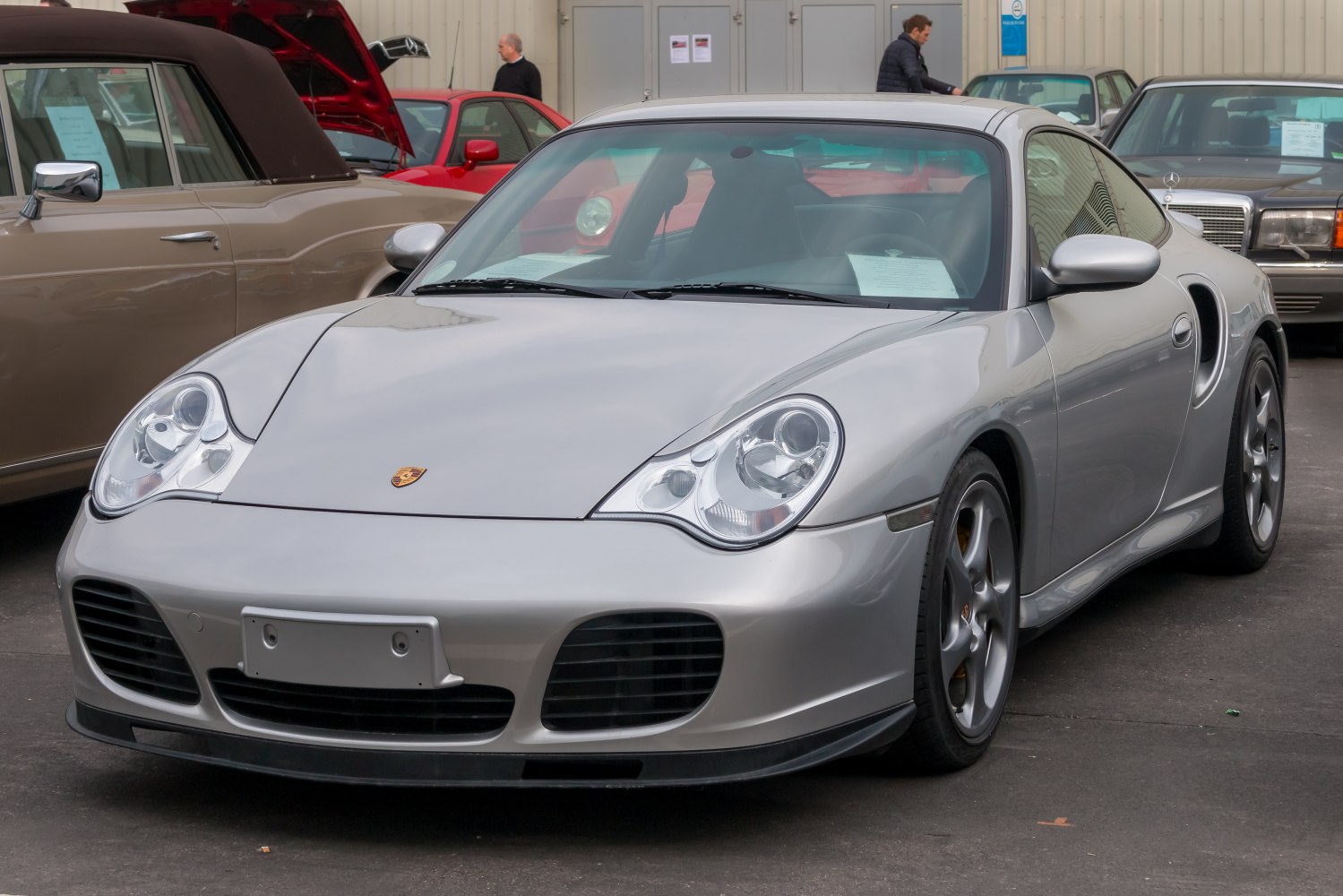 Silver sports coupe with oval headlights and large front air intakes