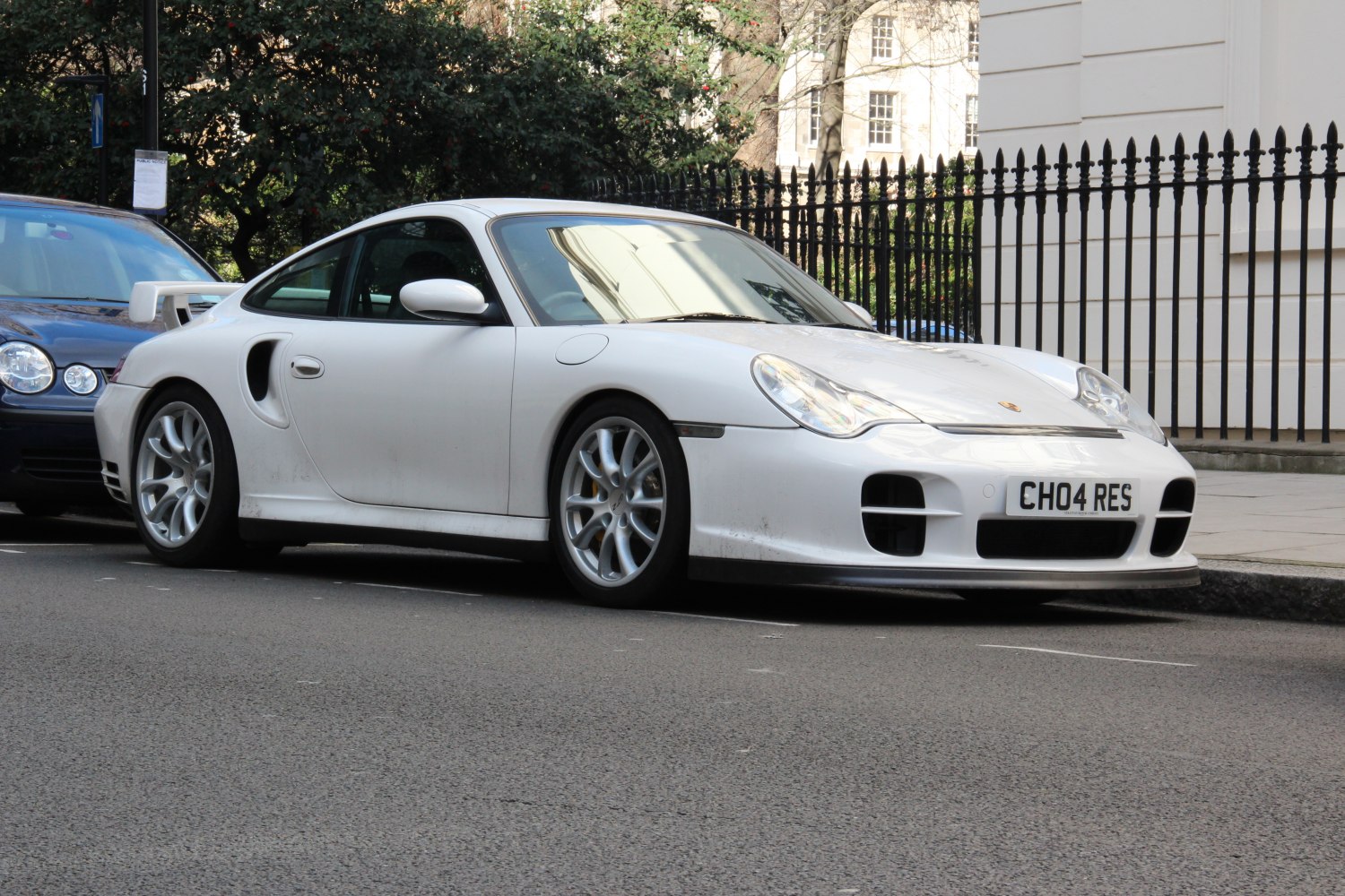 White 2002 sports coupe front side view with aerodynamic design and alloy wheels.