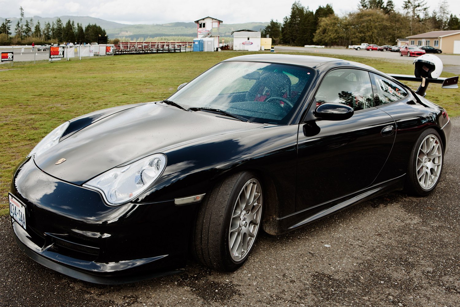 Black sports coupe with aerodynamic rear wing and performance wheels.