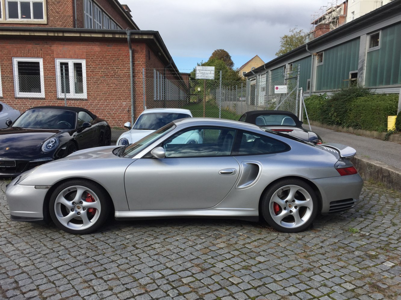 Silver coupe side profile with distinct turbo air intakes