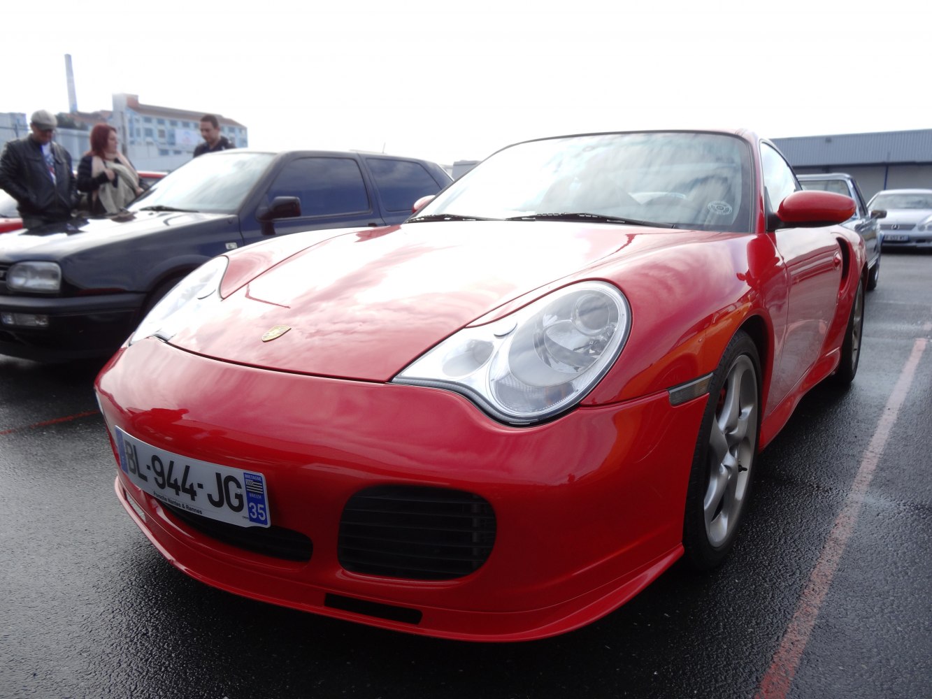 Close-up of red sports car front with distinct headlights and air intakes