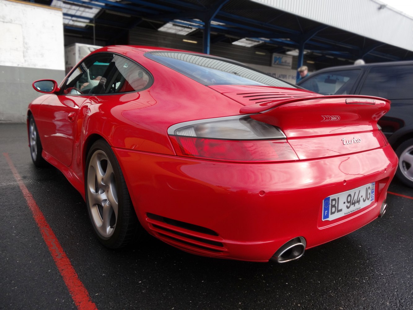 Rear view with spoiler and tail lights of a 2002 sports coupe