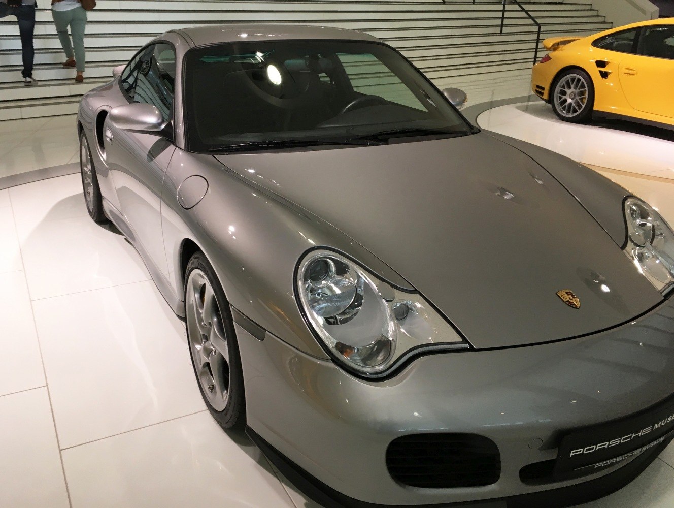 Close-up of silver sports car front with distinctive headlights.
