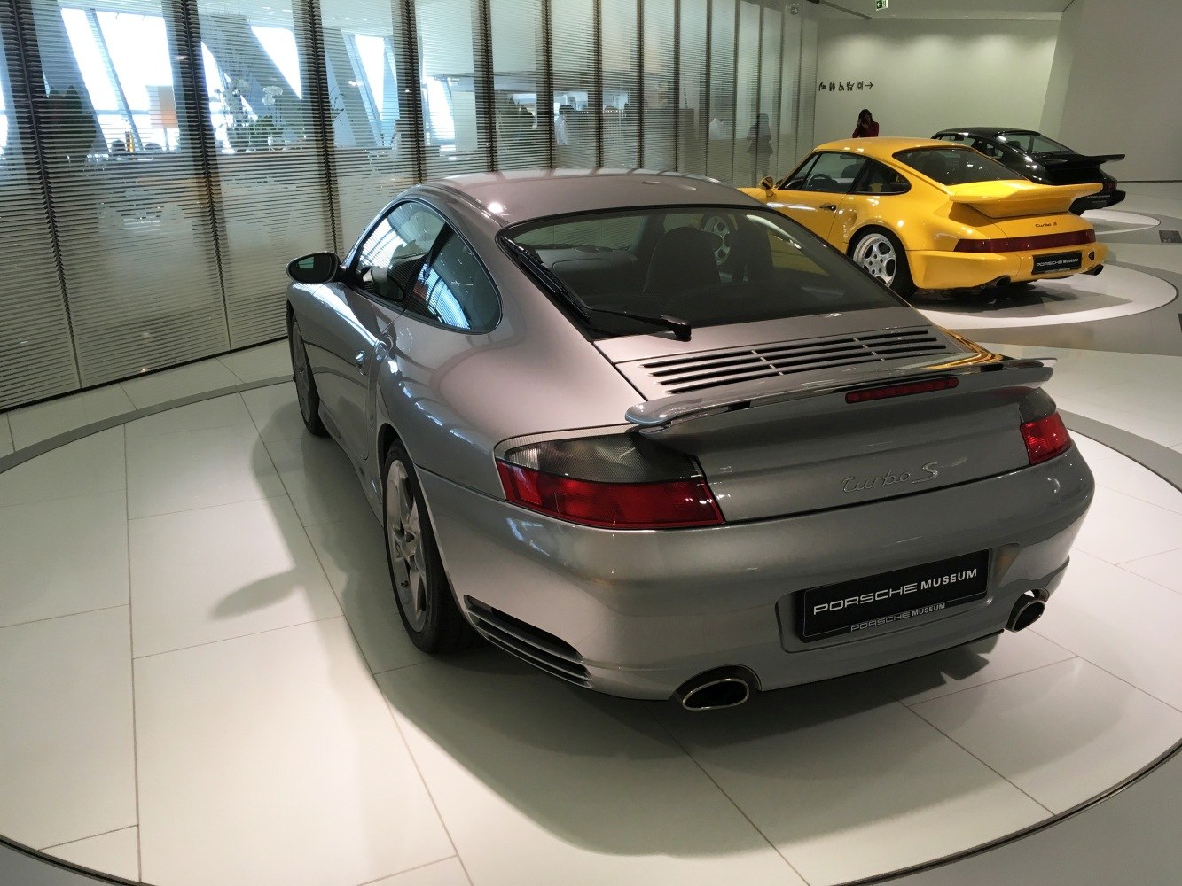 Rear view of a silver sports coupe with spoiler and dual exhausts