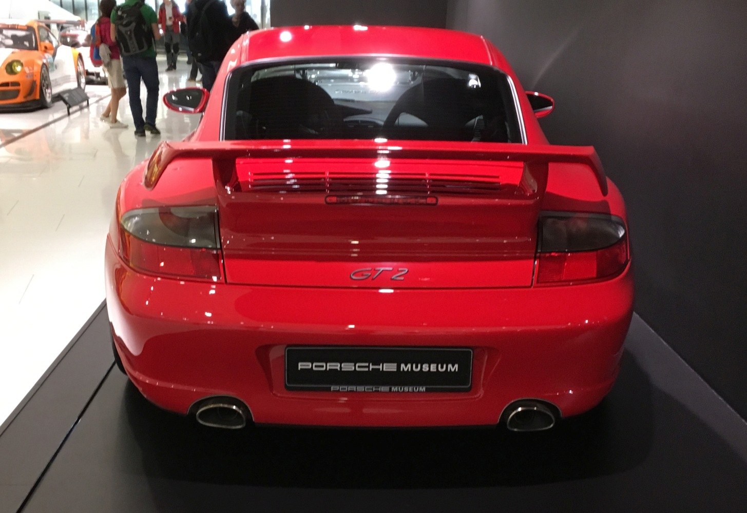 Rear view of a red Porsche 911 GT2 with dual exhaust and rear spoiler