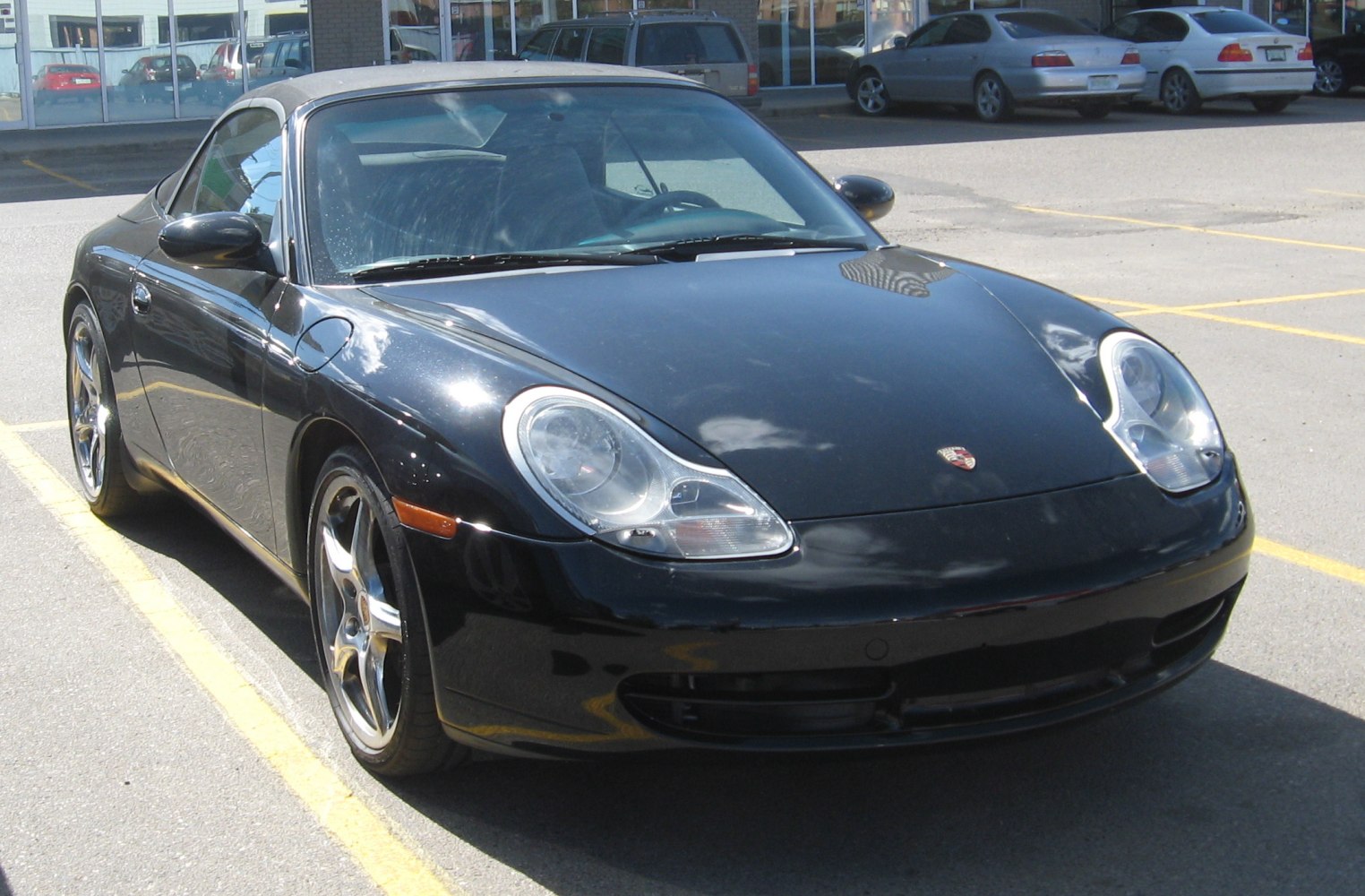 Convertible sports car front view with distinct headlights and alloy wheels