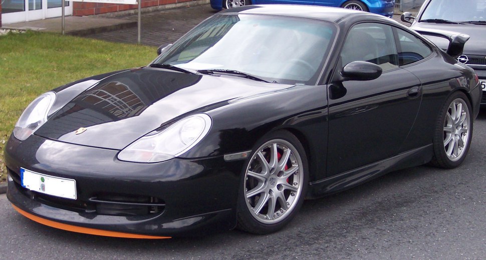 Black sports coupe with sleek front and side design, distinctive headlights, and alloy wheels