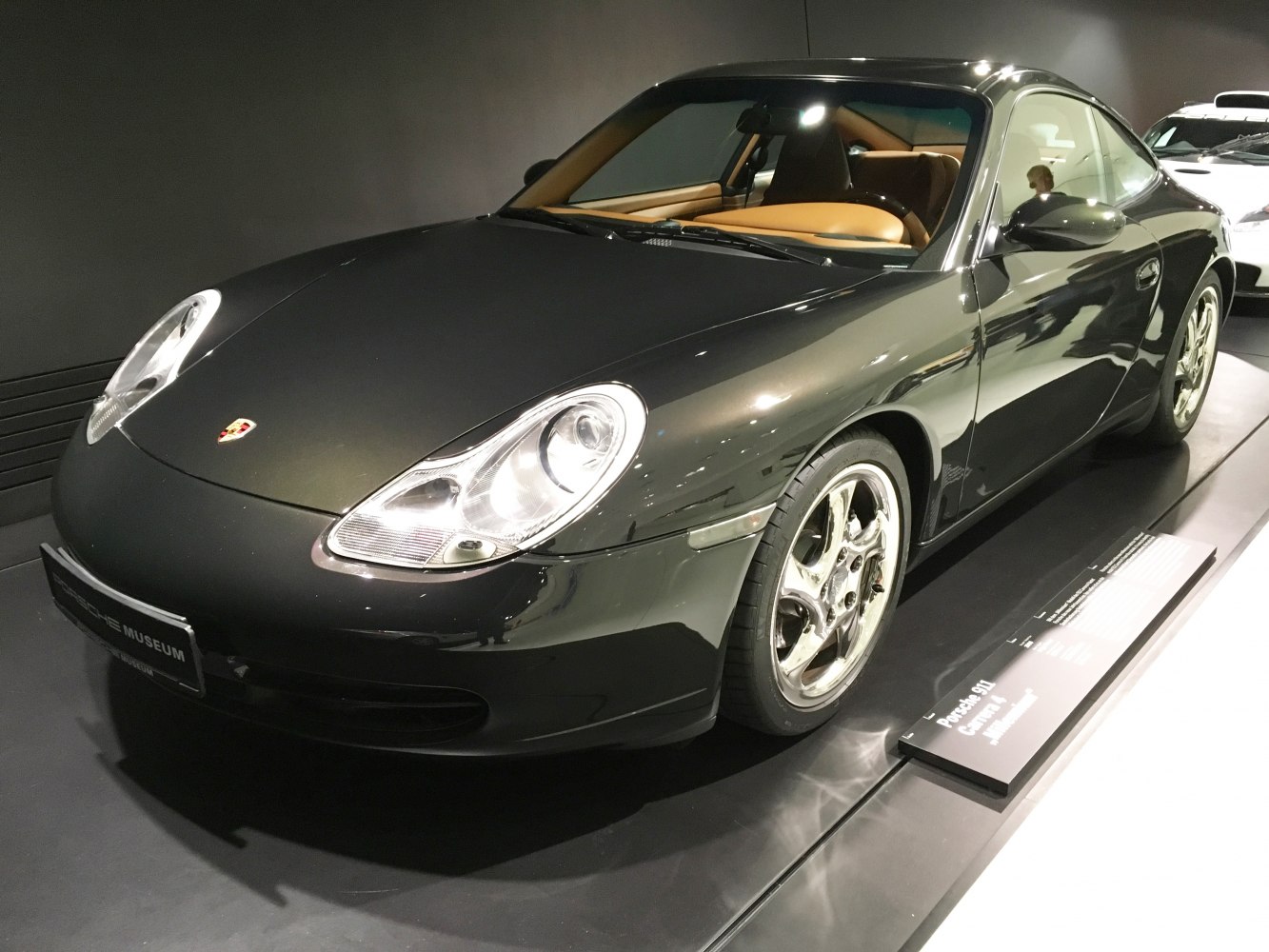 A black sports coupe with rounded headlights and aerodynamic design