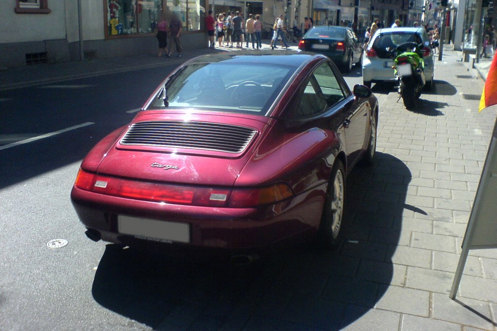 Rear view with distinctive Targa roof and wide rear light bar.