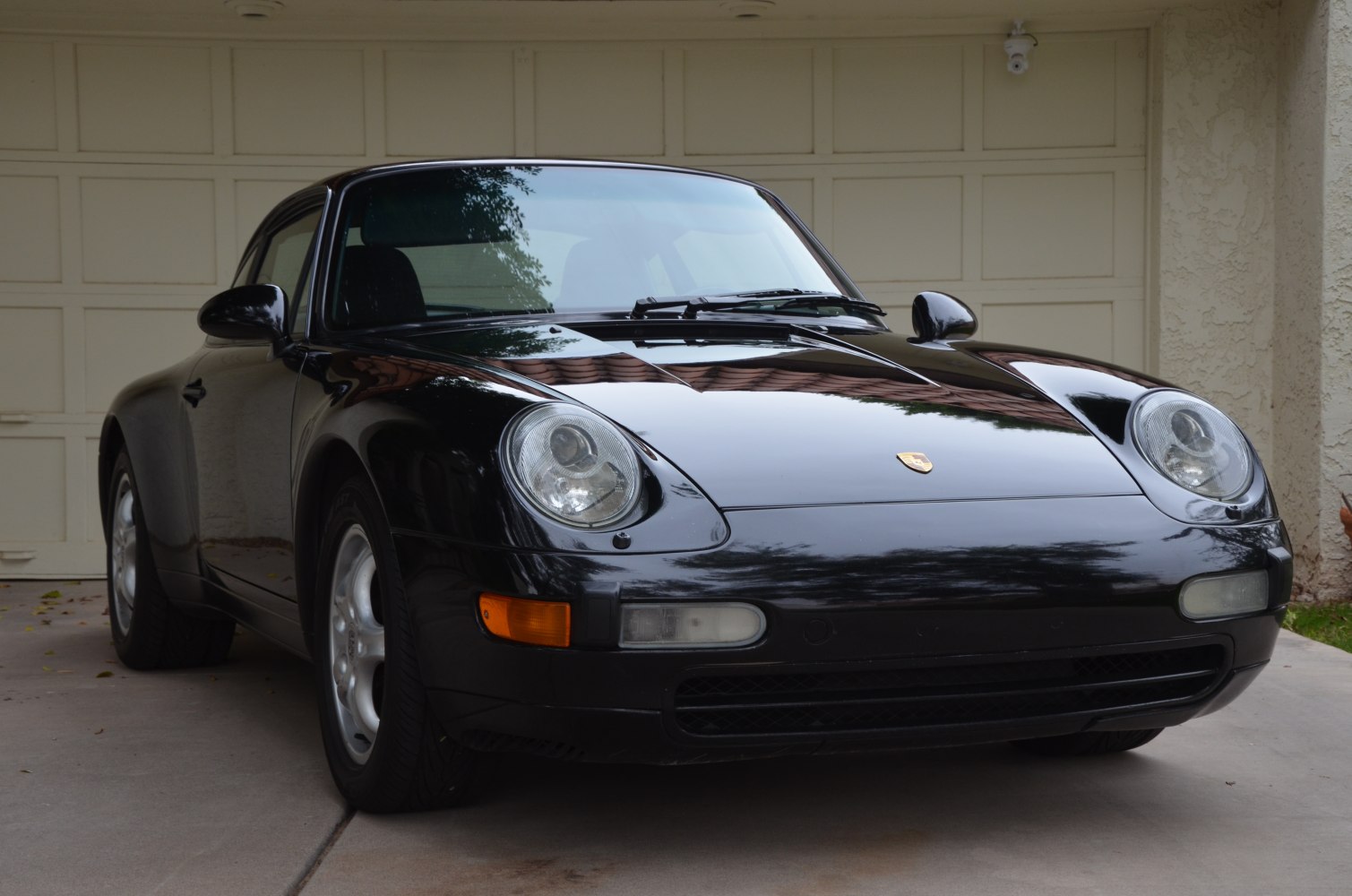 Front view showing round headlights and smooth hood of a sports car