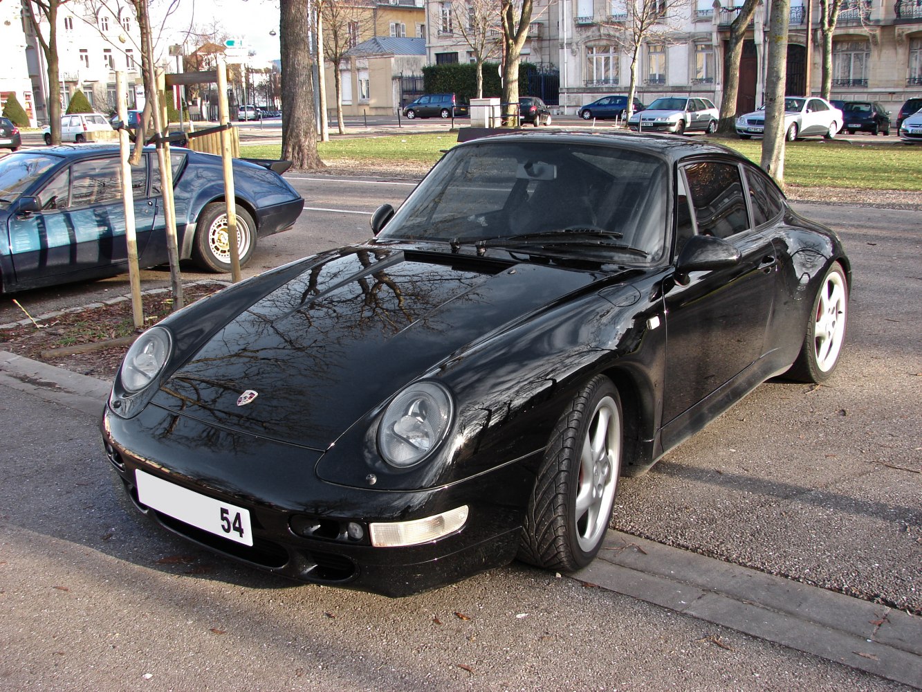 Black sports car front view with round headlights and sleek design