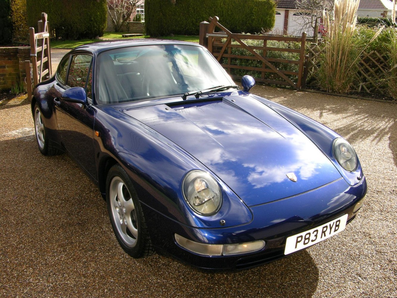 Front view showcasing round headlights and classic aerodynamic hood.