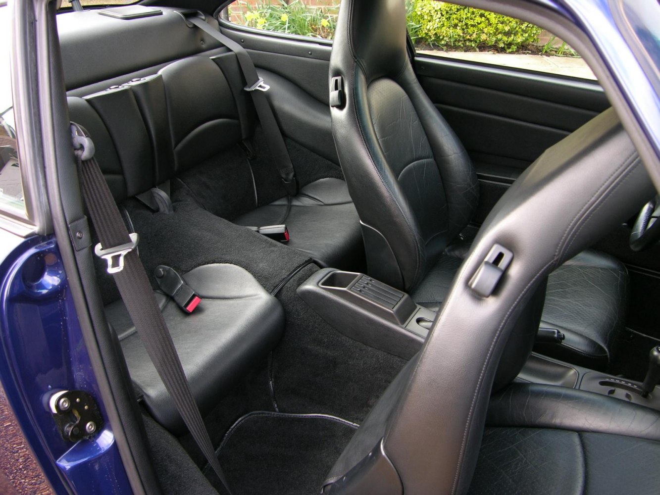 Black leather rear and front seats with center console in sports car interior