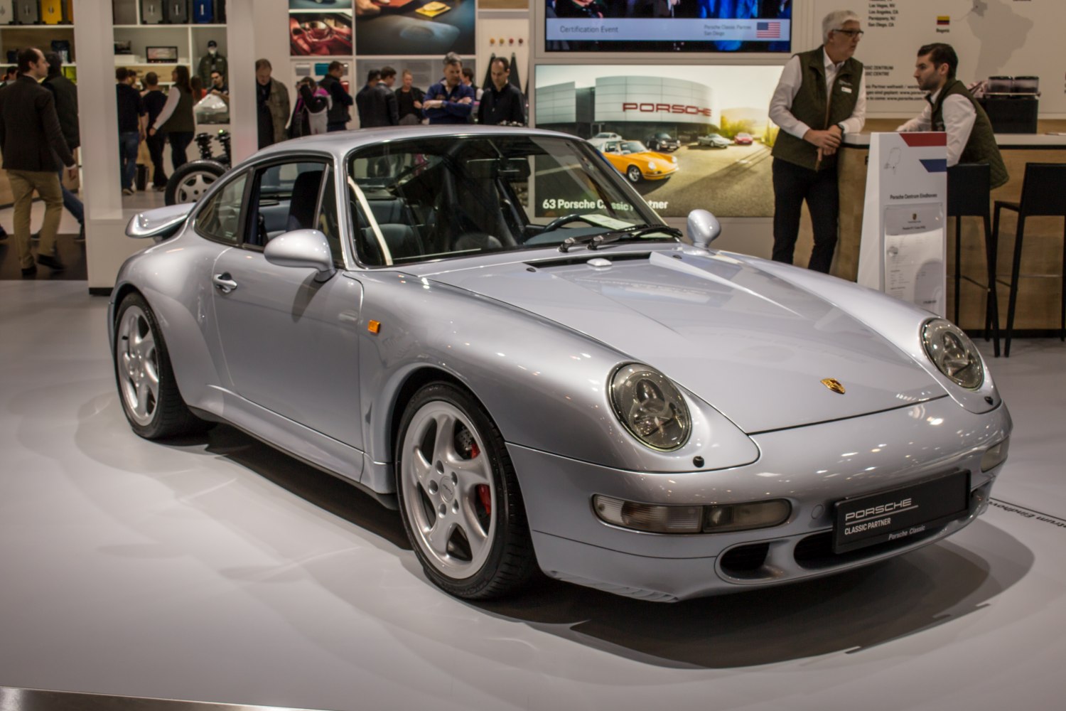 Silver classic sports coupe with rounded headlights and rear spoiler