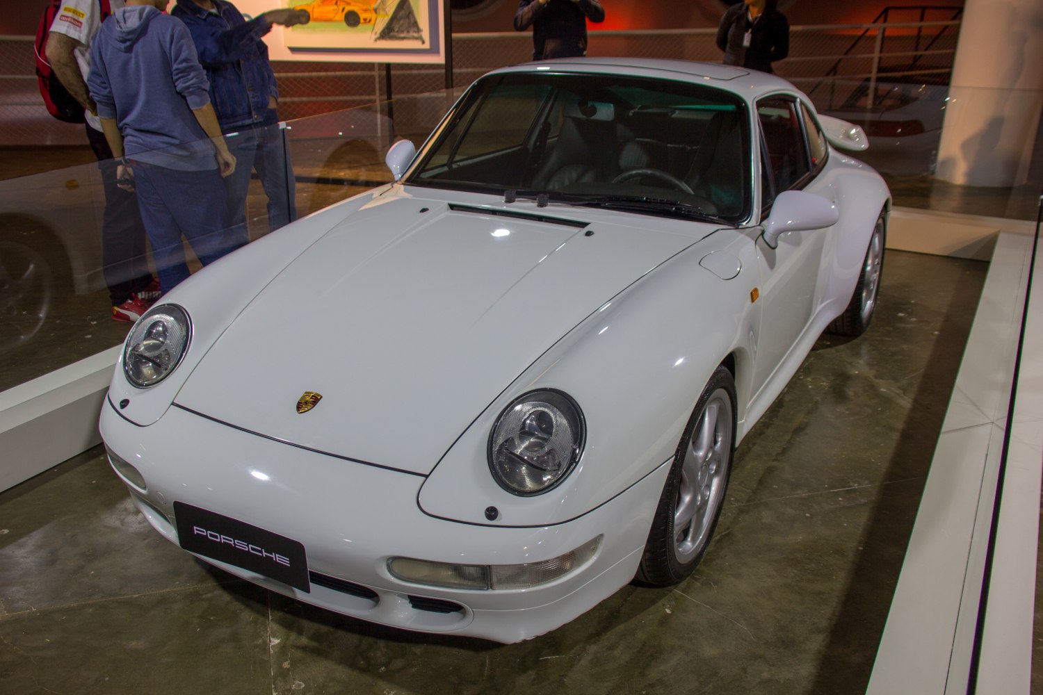 White sports coupe with rounded headlights and aerodynamic front design