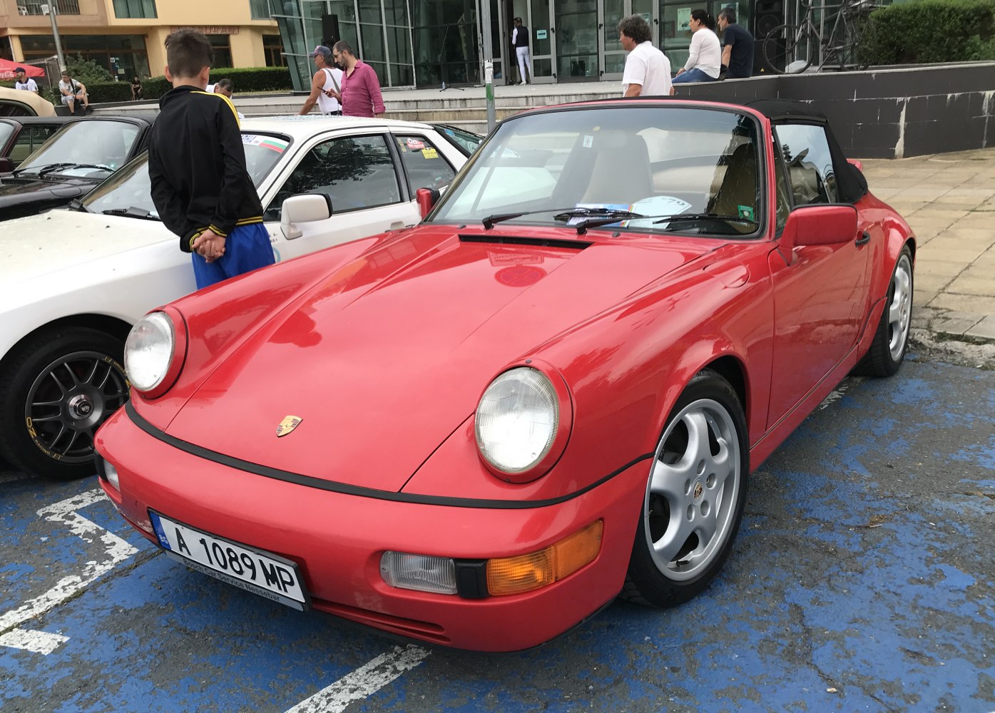 Red convertible with round headlights and classic Porsche front design