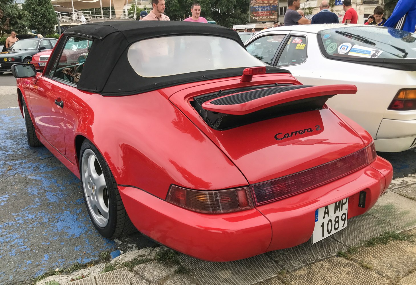 Rear view of a red convertible with open rear spoiler.