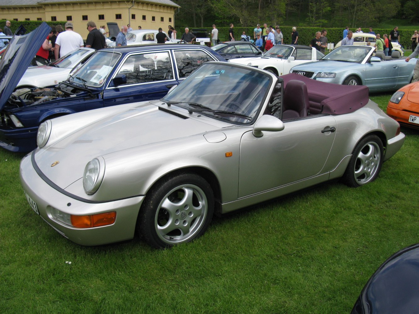 Silver Porsche convertible with folded soft top