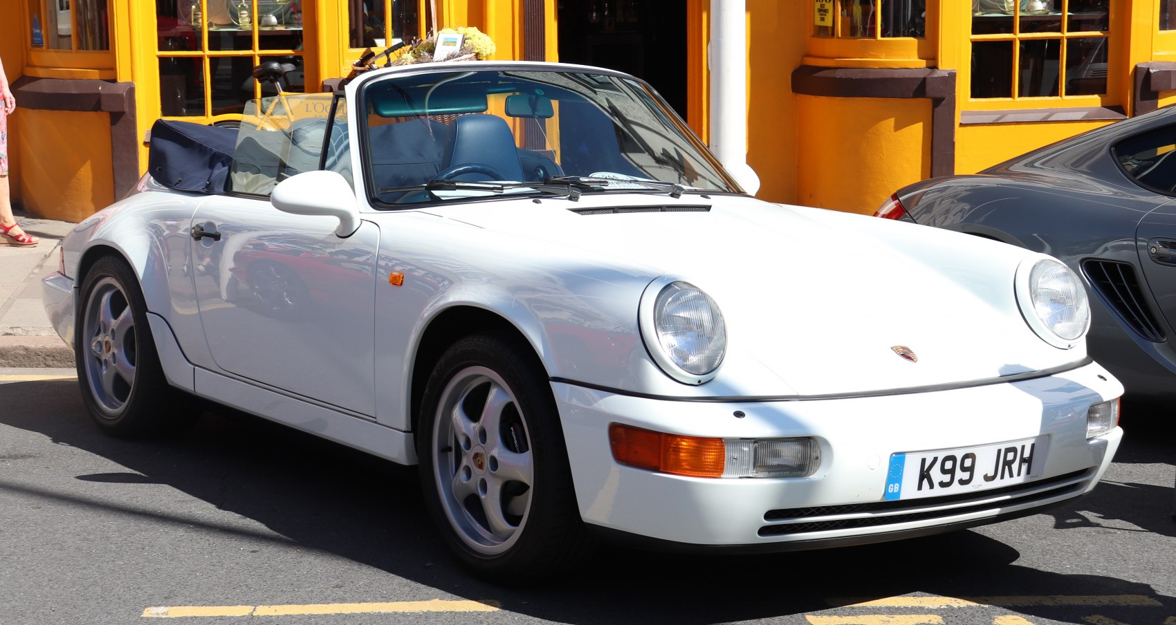 White convertible with classic round headlights and sleek body design