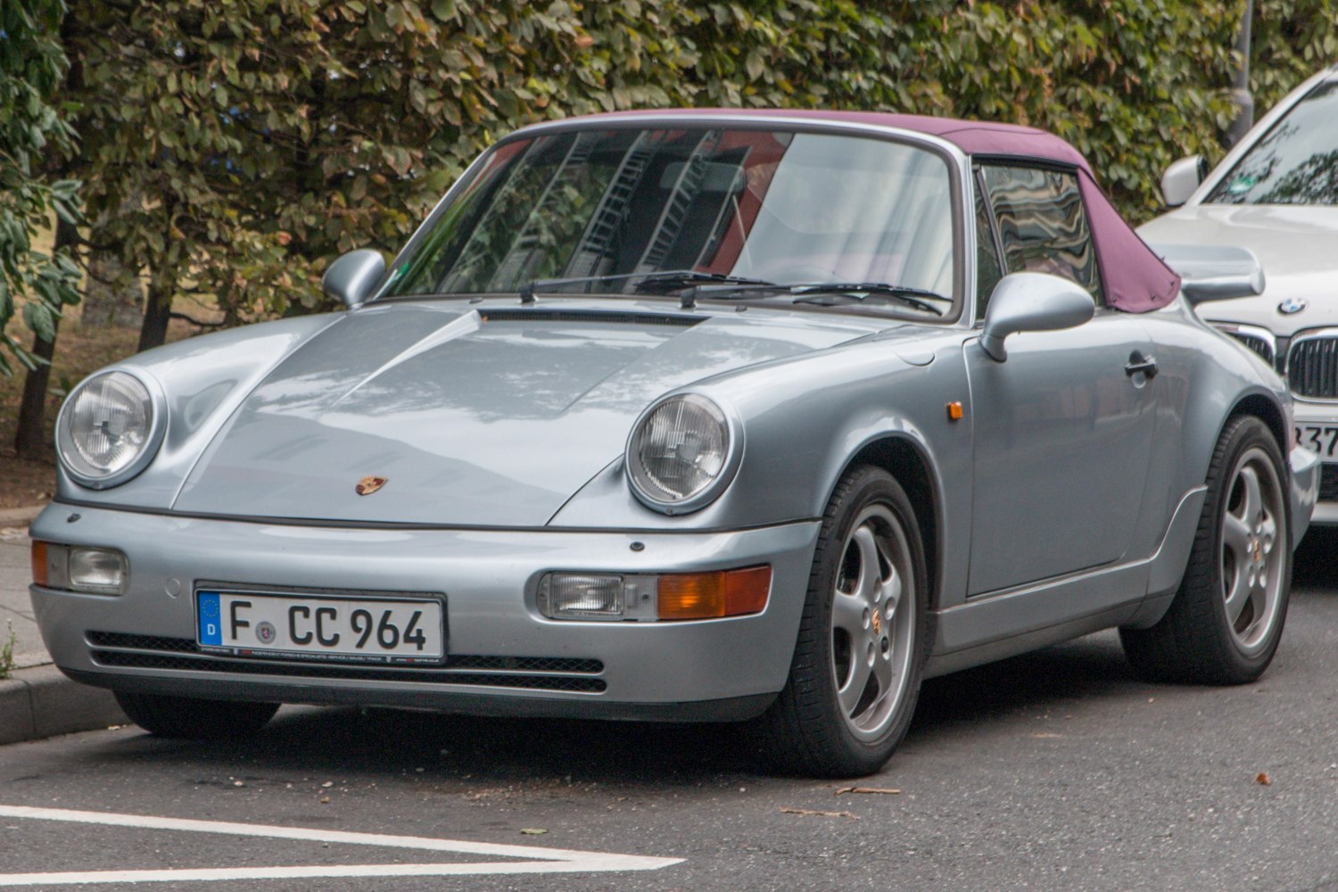 Silver Porsche 911 Cabriolet with purple soft top convertible roof