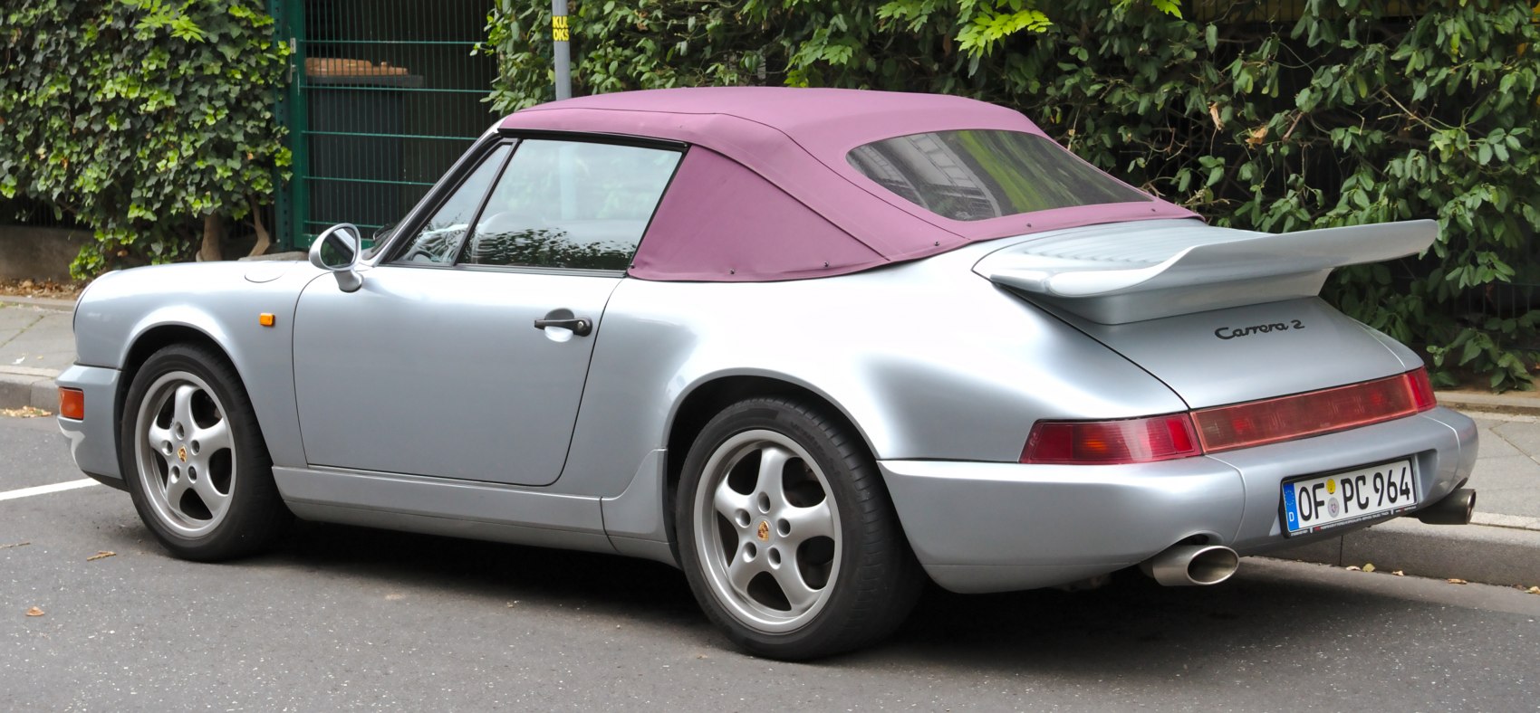 Silver sports car with purple soft convertible top and rear spoiler