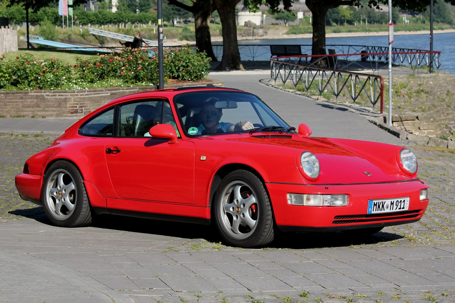 Red vintage coupe with round headlights and aerodynamic design