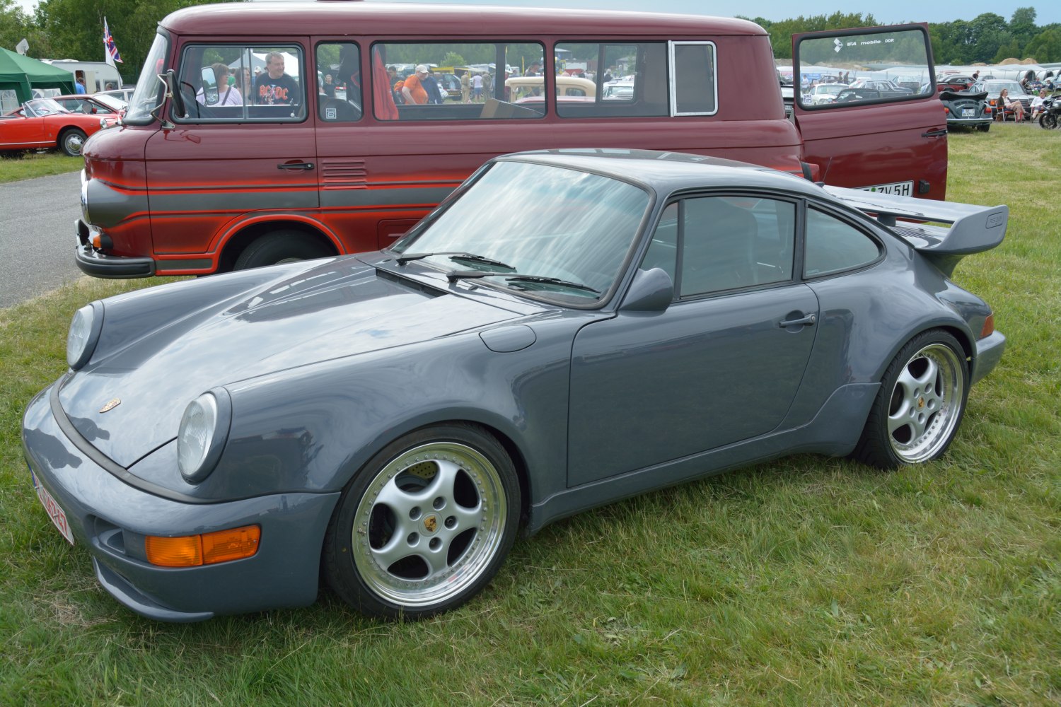 Wide body sports coupe with distinctive rear wing and polished wheels