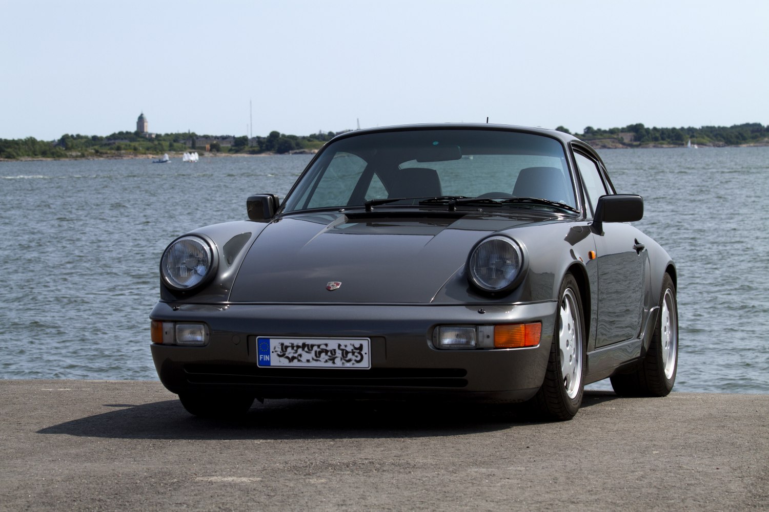 Front view of classic Porsche 911 with round headlights and sleek hood