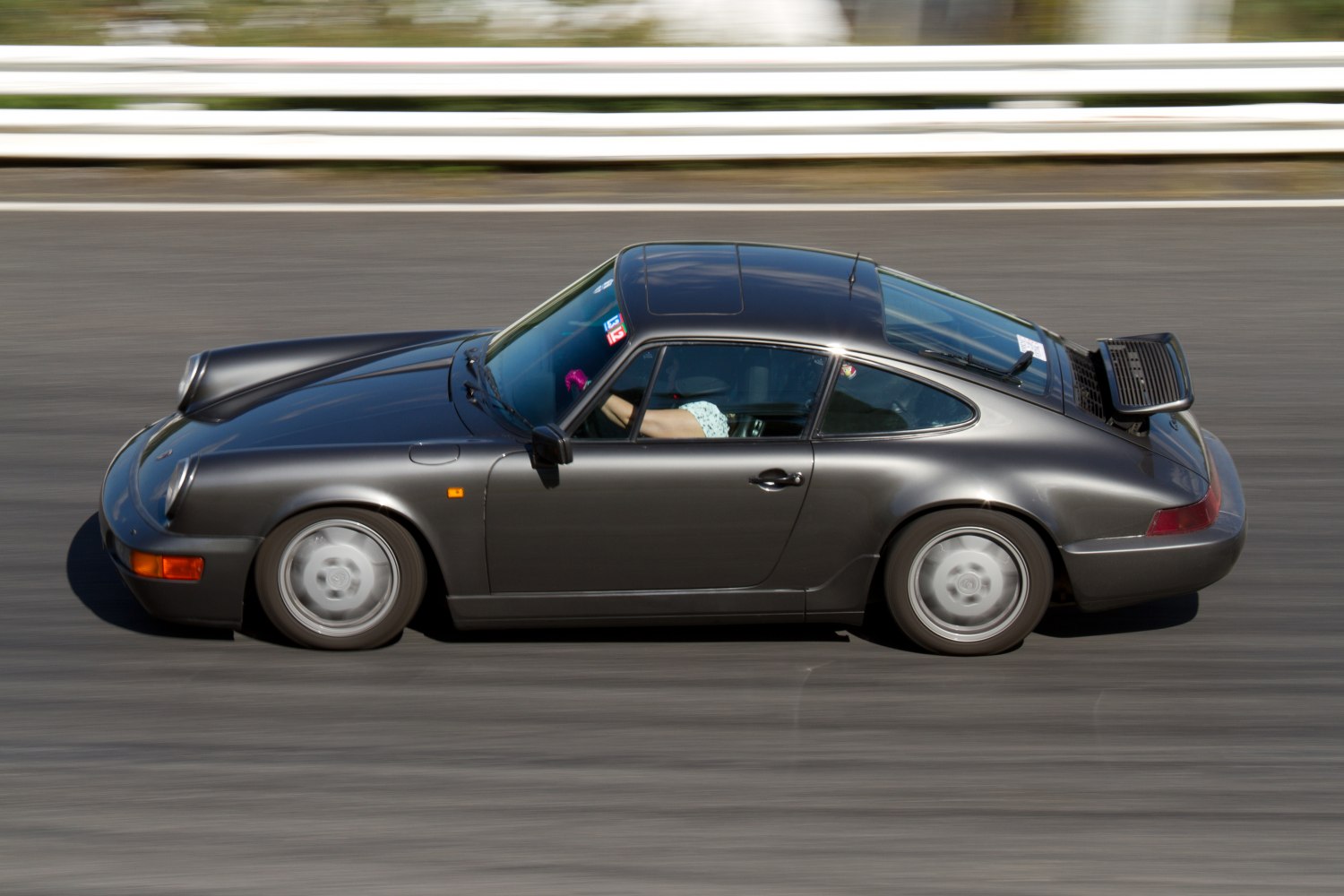 Side profile of classic sports car with rear wing and aerodynamic shape