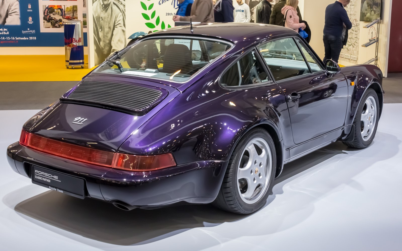 Vintage sports coupe with wide rear fender and rear light bar in high-gloss purple.