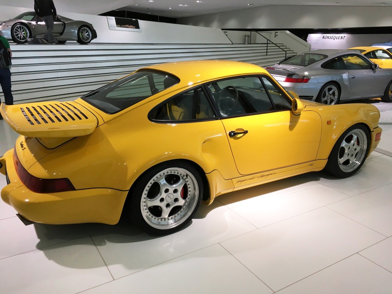 Yellow sports coupe with rear wing and wide rear fenders
