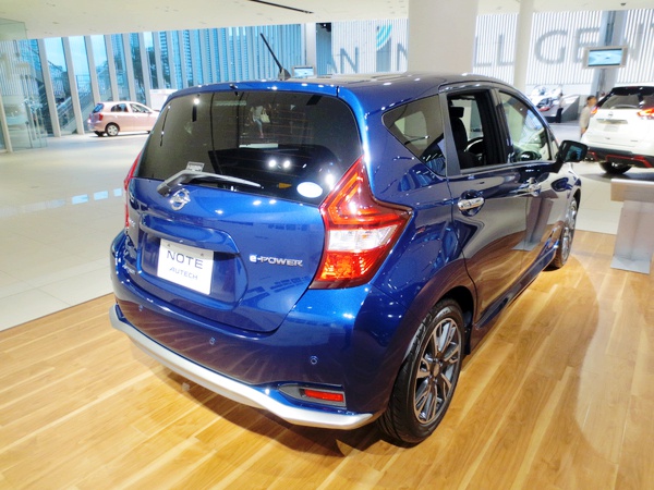 Blue hatchback rear with taillights and modern styling.