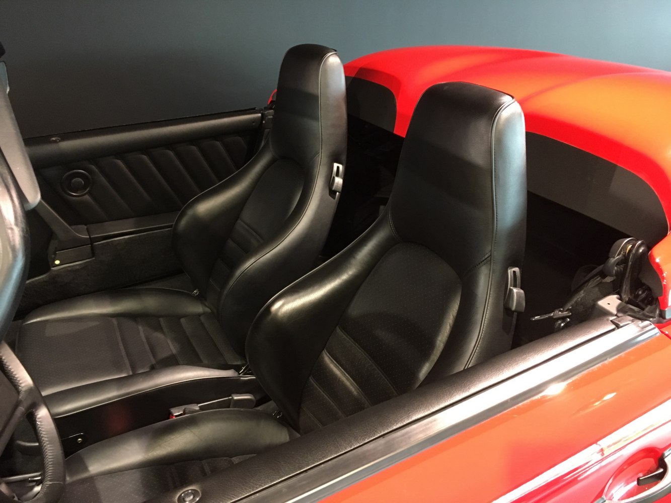 Black leather bucket seats and convertible interior detailing