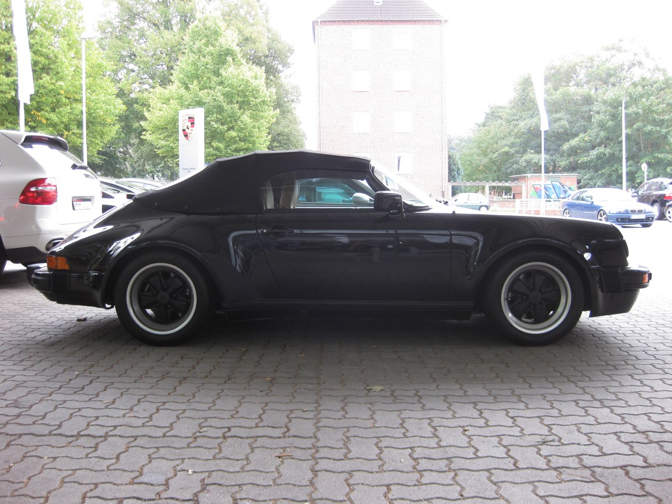Black convertible with soft top and vintage retro wheel design