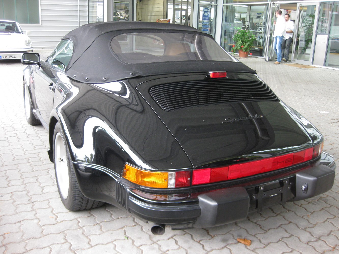Convertible rear view with soft top, spoiler, and classic black finish.