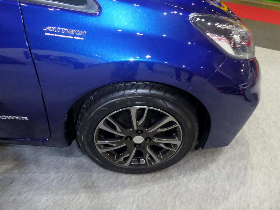 Close-up of car front fender with Autech badge and alloy wheel