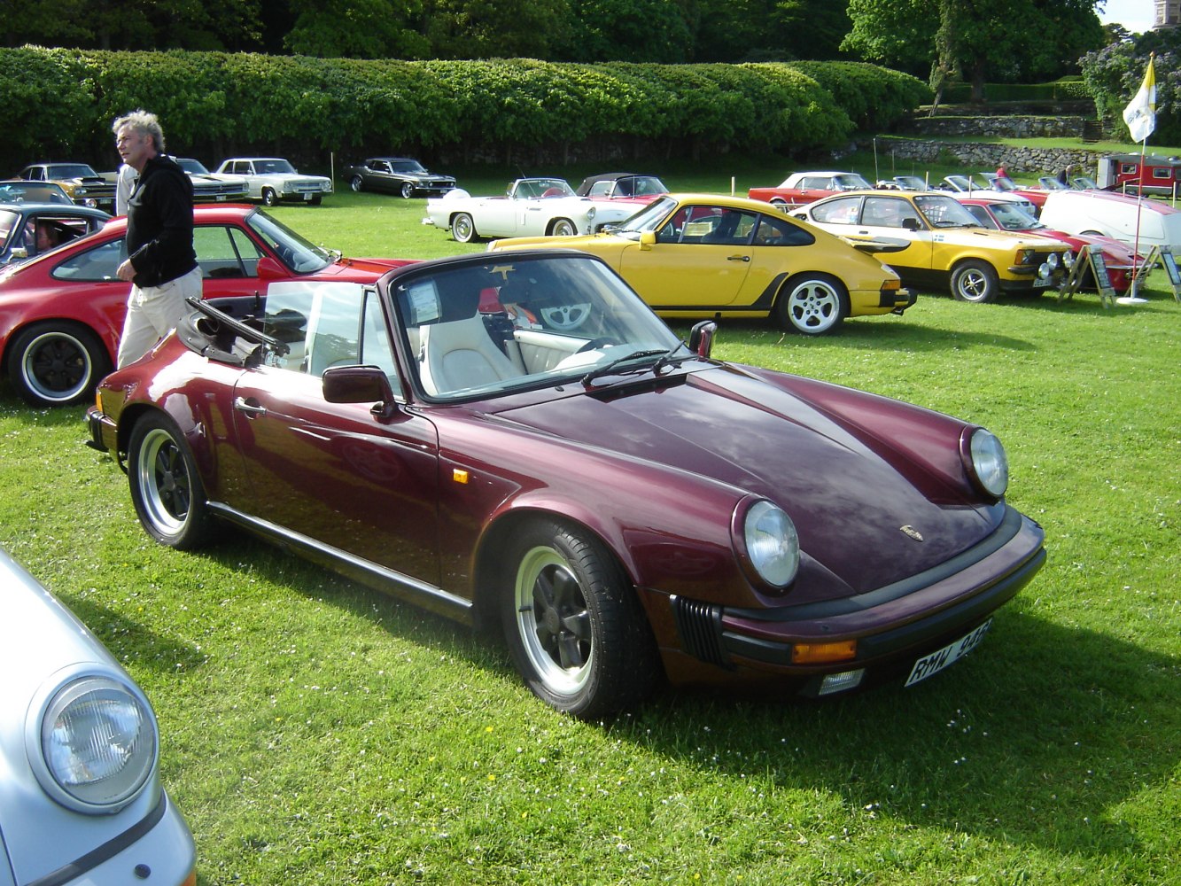 Classic 1980s convertible sports car with round headlights and alloy wheels.