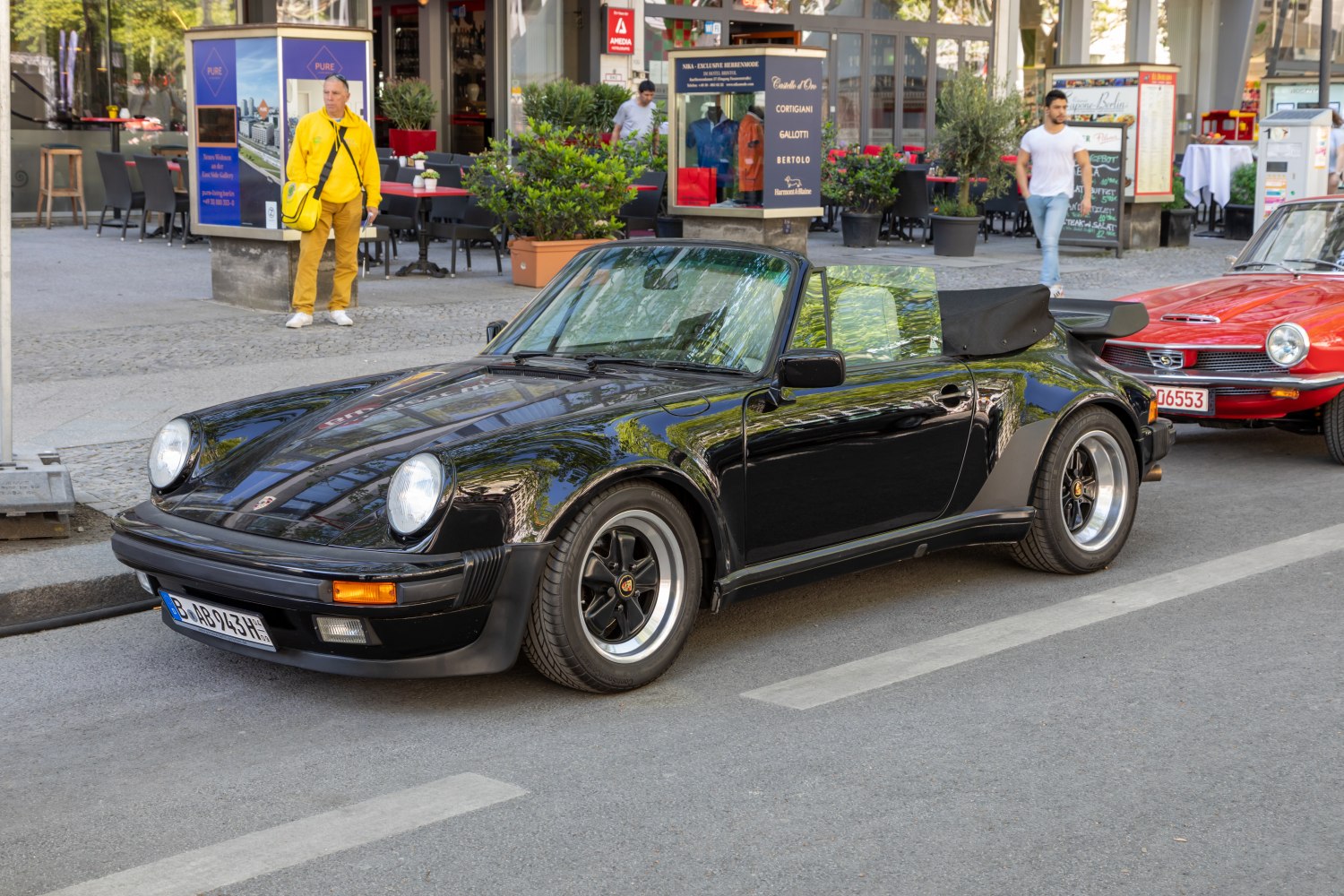 Black convertible with wide rear spoiler and round headlights