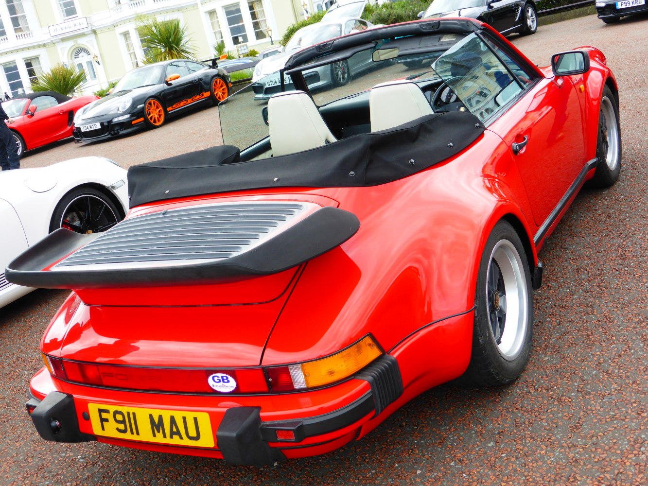 Red convertible with rear spoiler and wide rear fenders