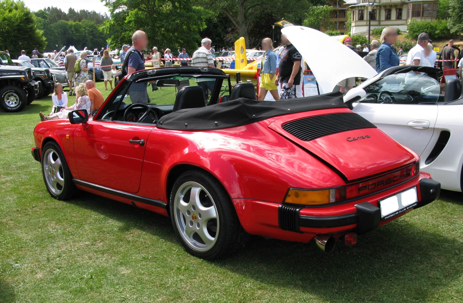 Red convertible Porsche 911 Cabriolet rear side with alloy wheels