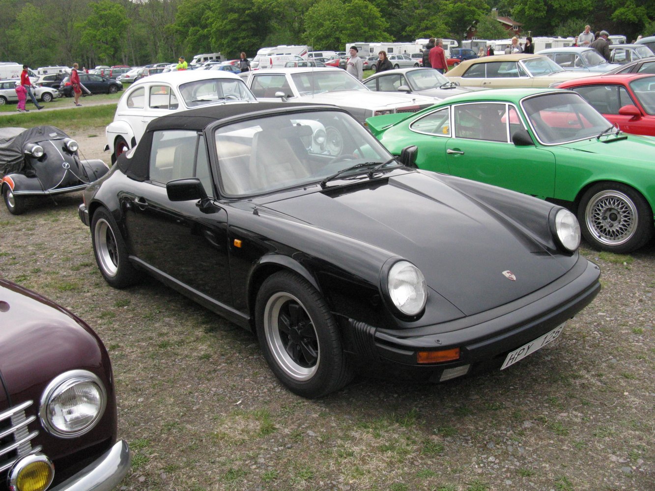 Black convertible with round headlights and alloy wheels