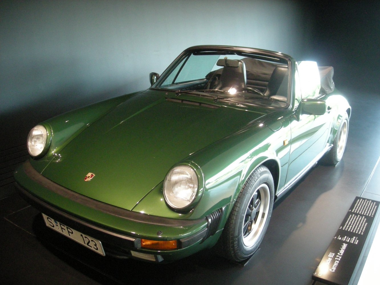 Classic convertible with round headlights and green paint.